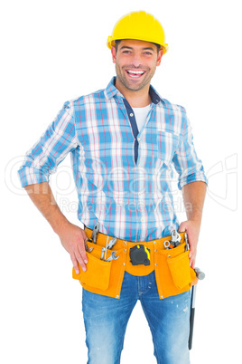 Confident handyman standing with hands on hips