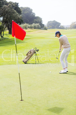 Female golfer putting her ball