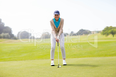 Female golfer putting her ball