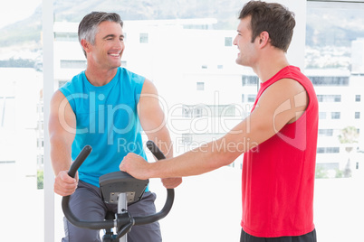 Trainer with man on exercise bike