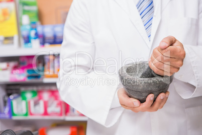 Pharmacist in lab coat mixing a medicine