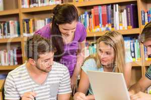 College students doing homework in library