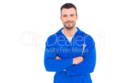 Happy mechanic holding spanner on white background
