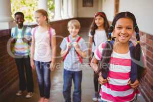 Smiling little school kids in school corridor
