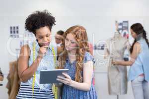 Fashion designers using digital tablet