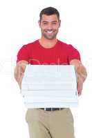 Happy delivery man giving pizza boxes