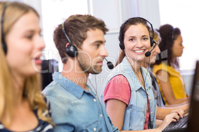 Students using headsets in computer class