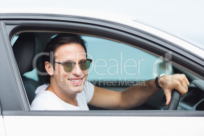 Man driving and smiling at camera