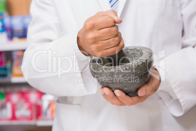 Pharmacist in lab coat mixing a medicine