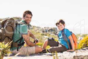 Father and son hiking through mountains