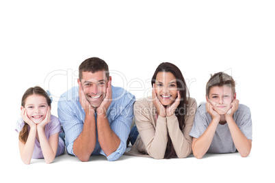 Happy family lying with head in hands