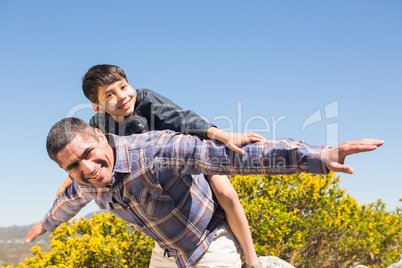 Father and son hiking through mountains