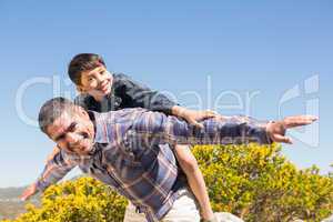 Father and son hiking through mountains