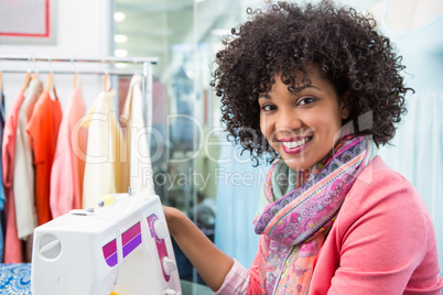 Female fashion designer using sewing machine