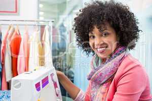 Female fashion designer using sewing machine