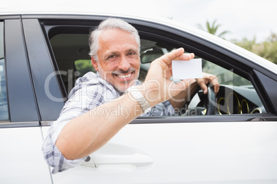 Man smiling and holding card