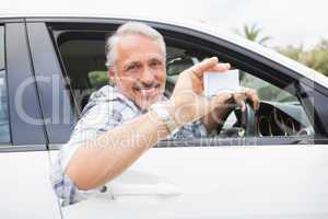 Man smiling and holding card