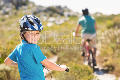 Father and son biking through mountains