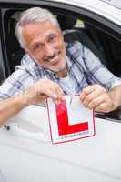 Driver smiling and tearing l plate