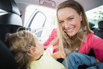 Happy mother playing with her daughter