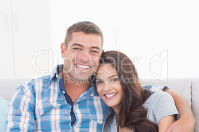 Loving couple smiling at home