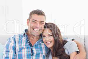 Loving couple smiling at home