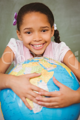 Cute little girl holding globe