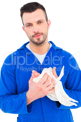 Mechanic wiping hands with cloth