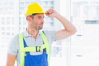 Manual worker wearing yellow hard hat