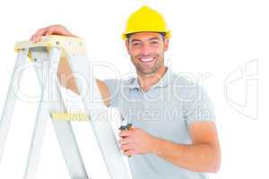 Portrait of happy repairman with pliers climbing ladder