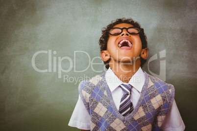 Boy laughing in front of blackboard