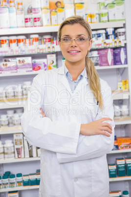 Portrait of a smiling student in lab coat with arms crossed