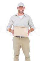 Portrait of happy delivery man with cardboard box