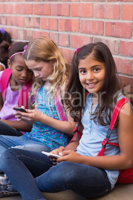 Cute pupils using mobile phone