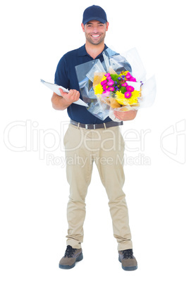 Happy flower delivery man holding clipboard