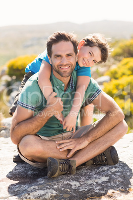 Father and son hiking through mountains