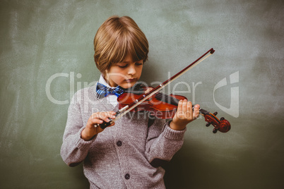 Portrait of cute little boy playing violin