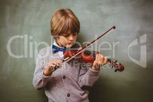 Portrait of cute little boy playing violin