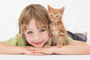 Boy with kitten over white background