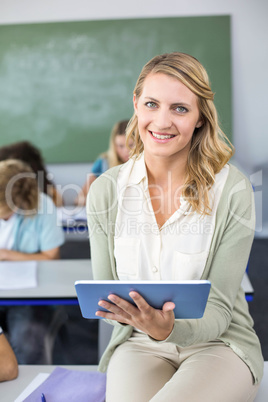 Female teacher using digital tablet in class