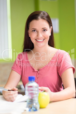 Female student doing homework in library