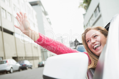 Young woman smiling and waving