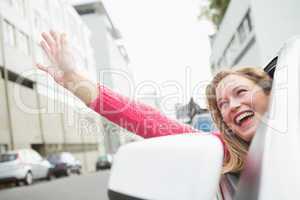 Young woman smiling and waving