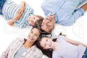 Happy parents and children lying on white background