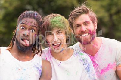 Happy friends covered in powder paint