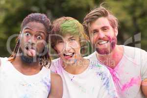 Happy friends covered in powder paint