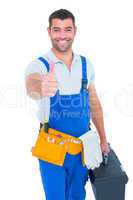 Happy repairman with toolbox gesturing thumbs up