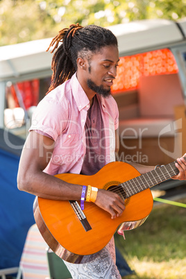 Handsome hipster playing the guitar