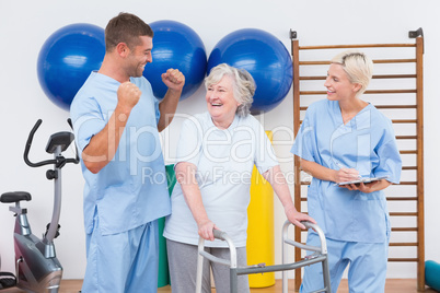 Smiling therapists with invalid woman