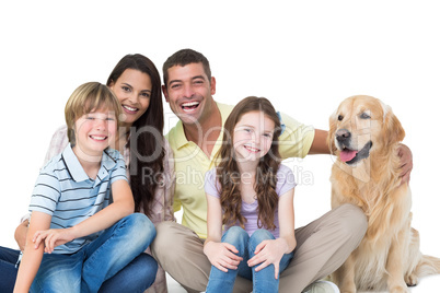 Family with golden retriever against white background